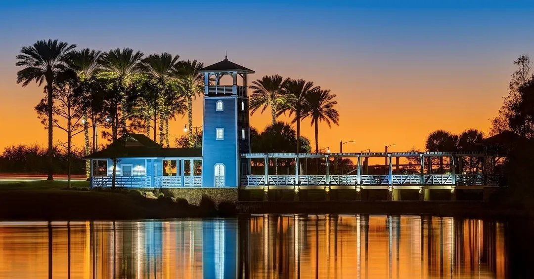 The lighthouse-style tower and boardwalk at Lake Tradition, lit at twilight in Port St. Lucie